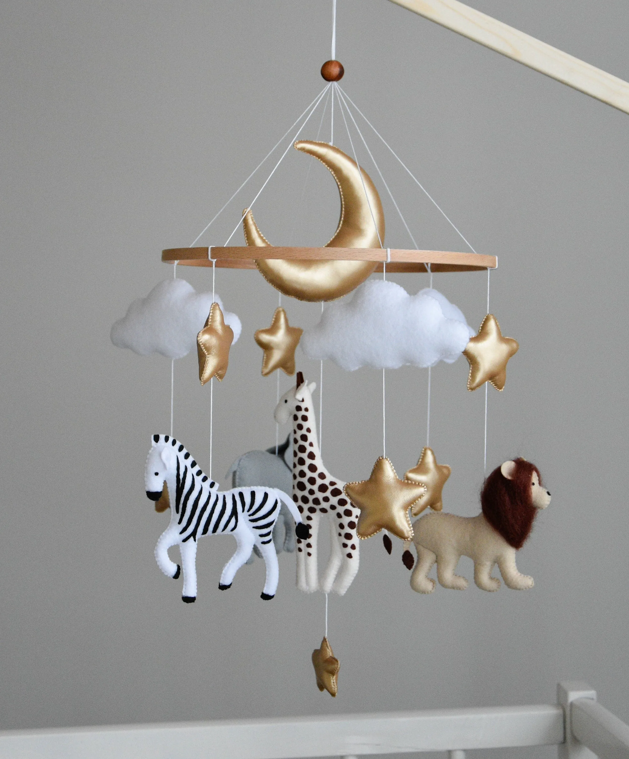 Safari mobile with giraffe, lion, elephant, moon, stars and clouds